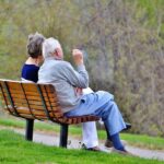 senior citizen sittin on a park talking nonprofit grant