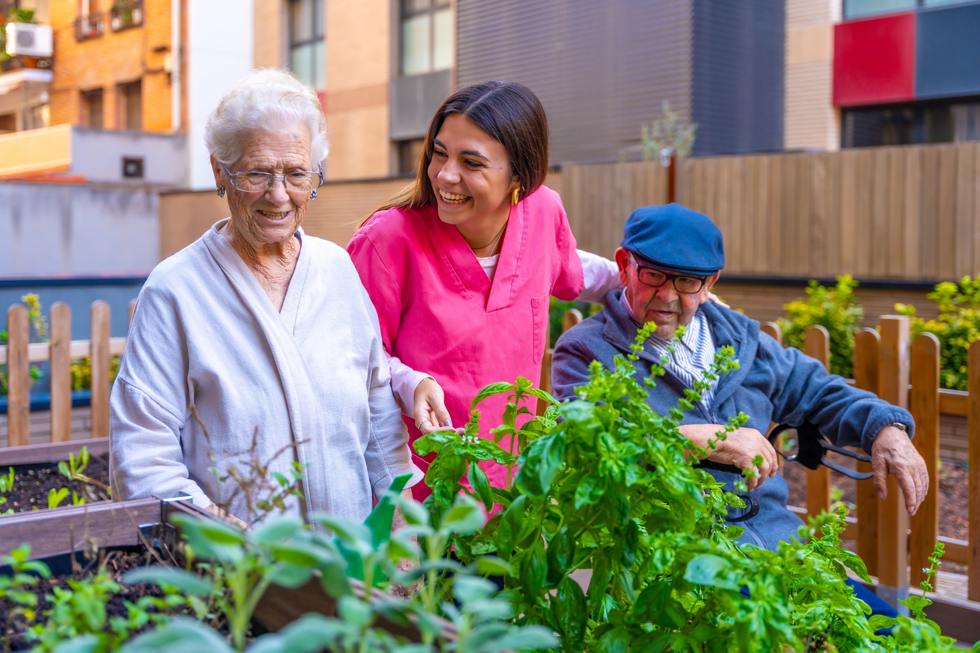 Nurse and elder people in a garden in a geriatric